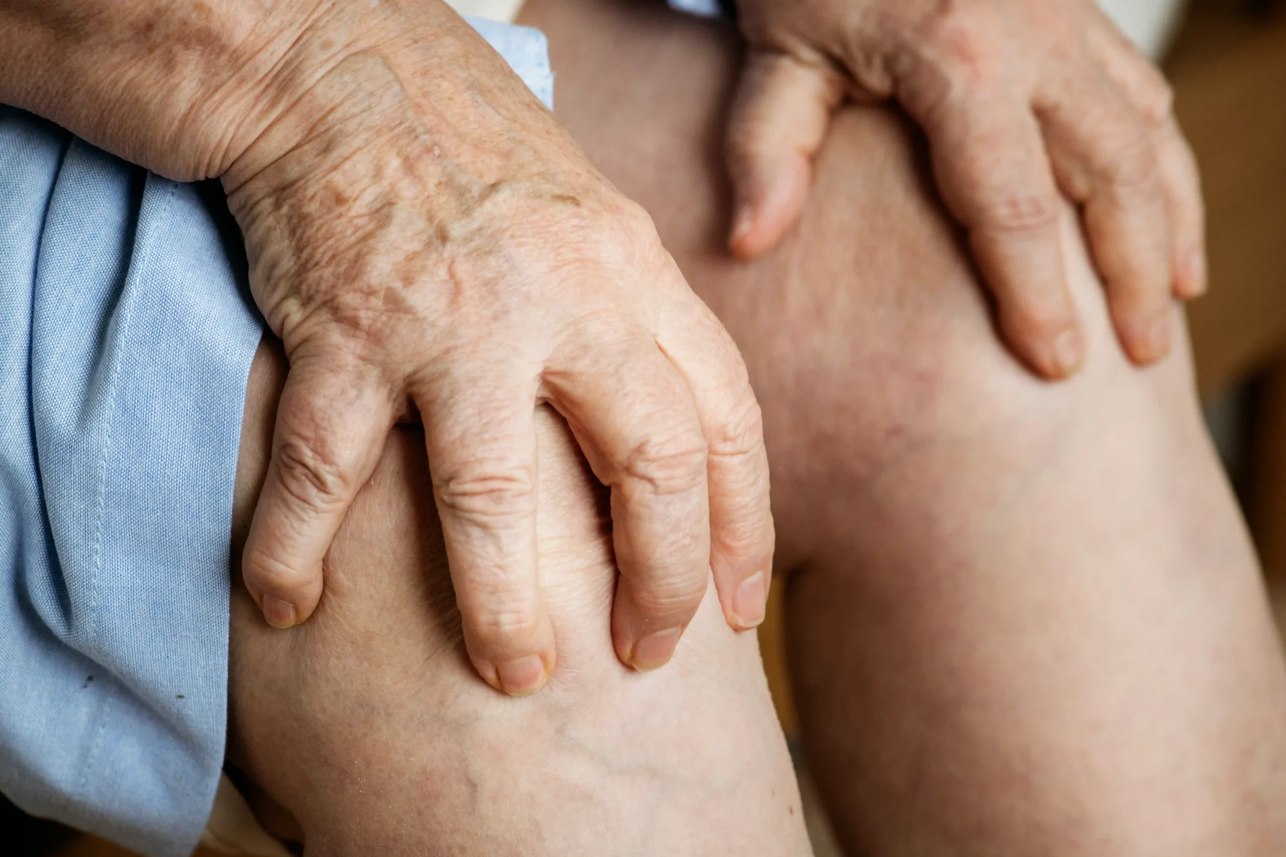 elderly woman holding her knees